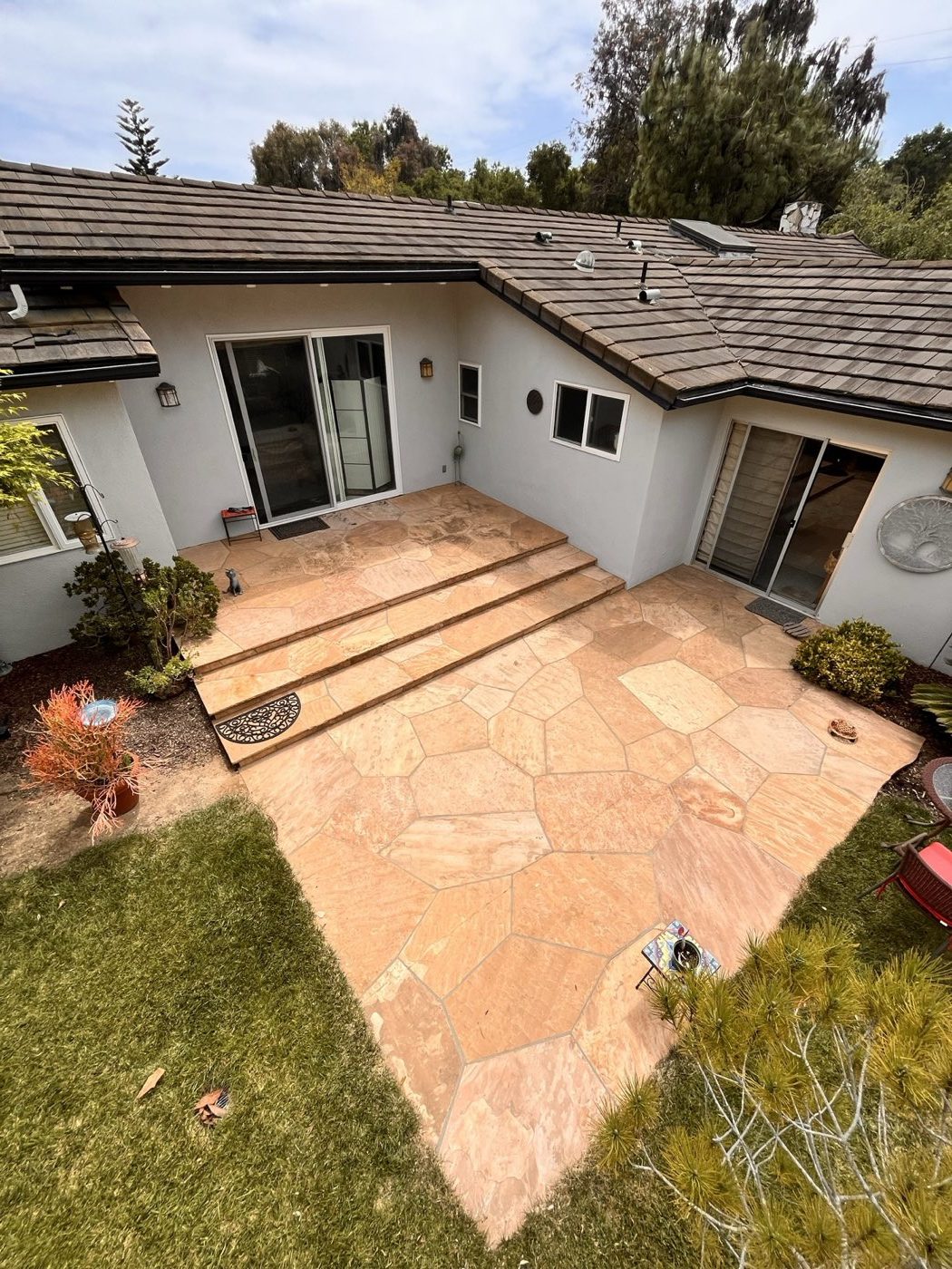 Flagstone courtyard patio after cleaning, warm stone color restored and ready to seal