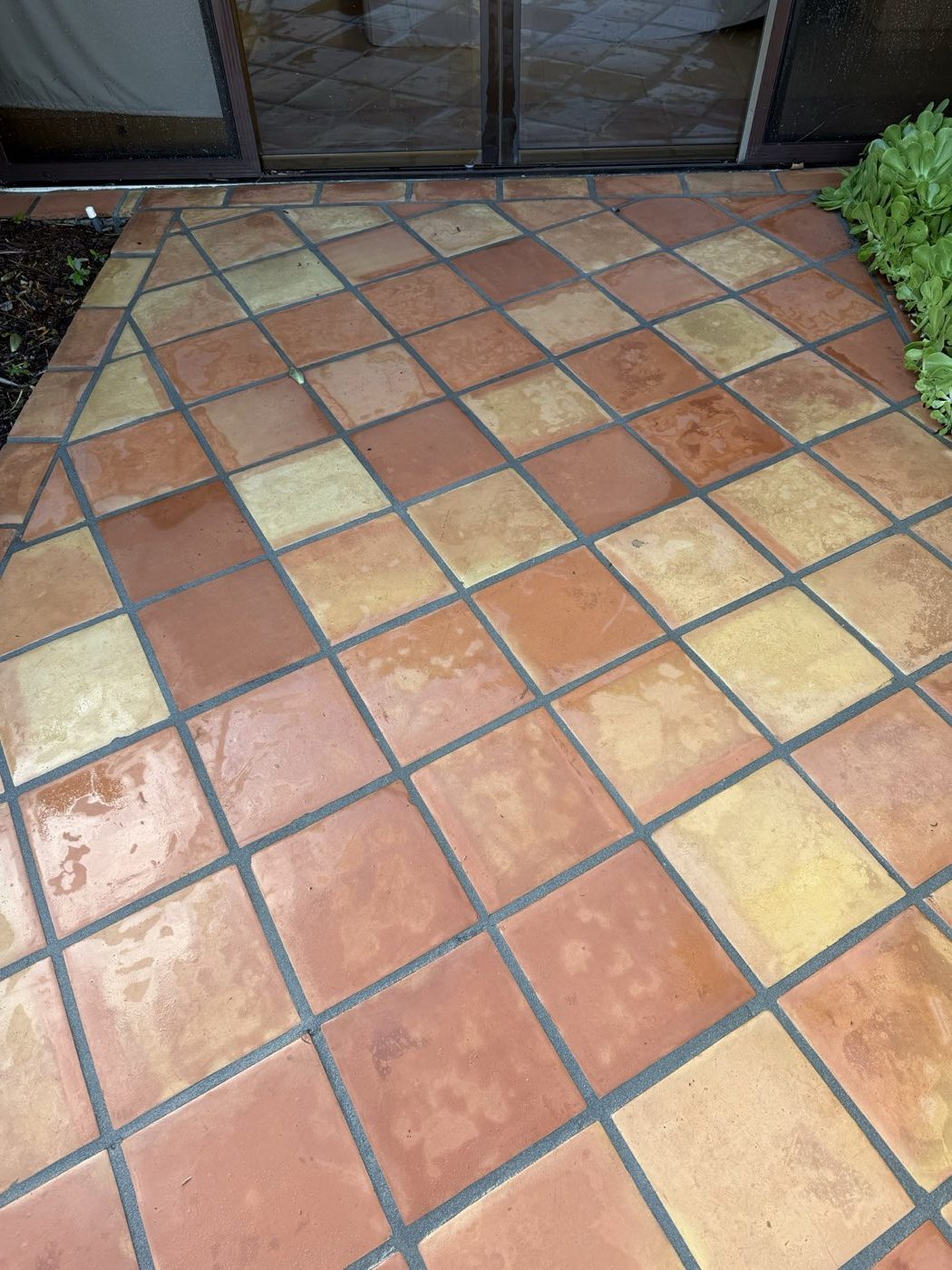 Tile courtyard after pressure washing, bright and uniformly clean