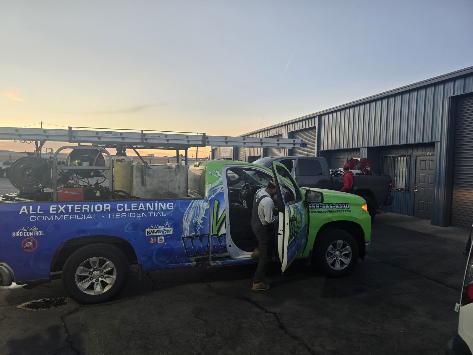 Valley Wash Pros truck set up for an exterior pressure washing job at an industrial warehouse