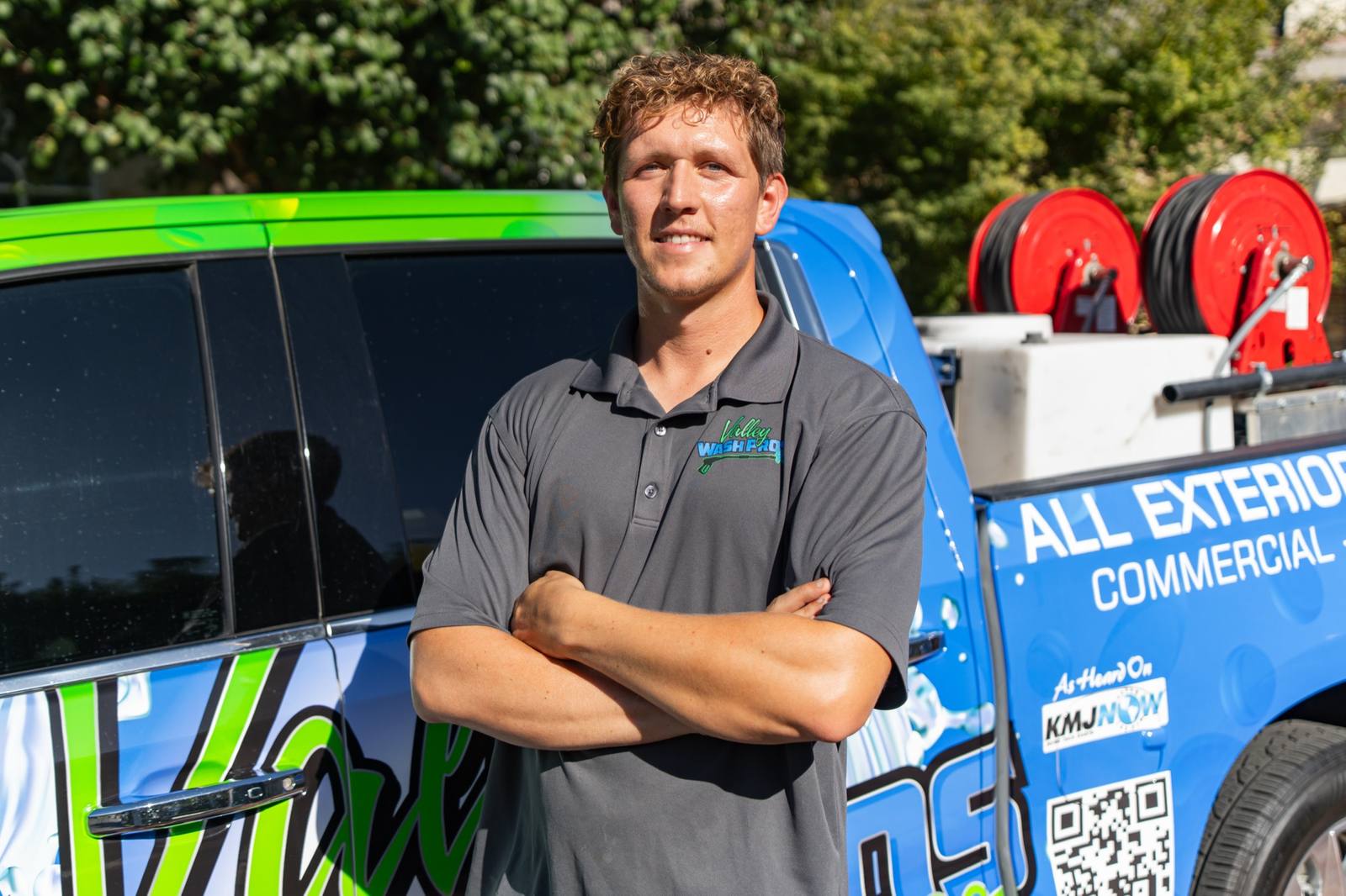 Valley Wash Pros owner standing in front of the company's wrapped service van