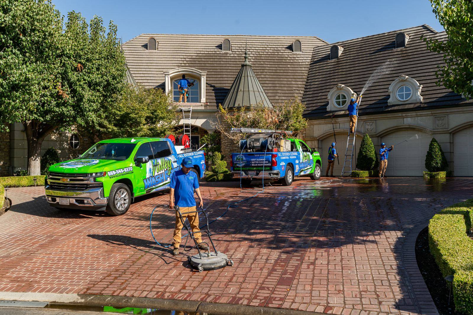 Surface cleaner running across a paver driveway on a Clovis area home