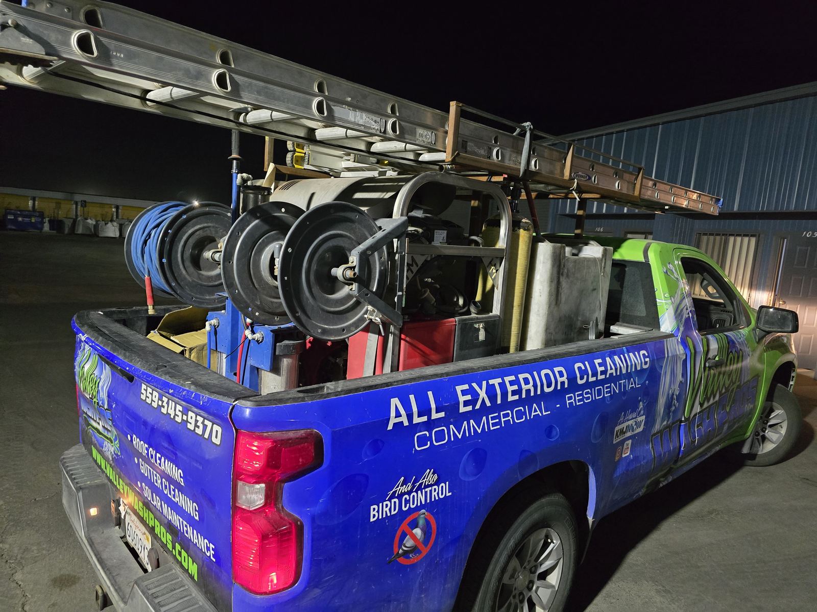 Valley Wash Pros truck loaded with hose reels and pressure washing equipment