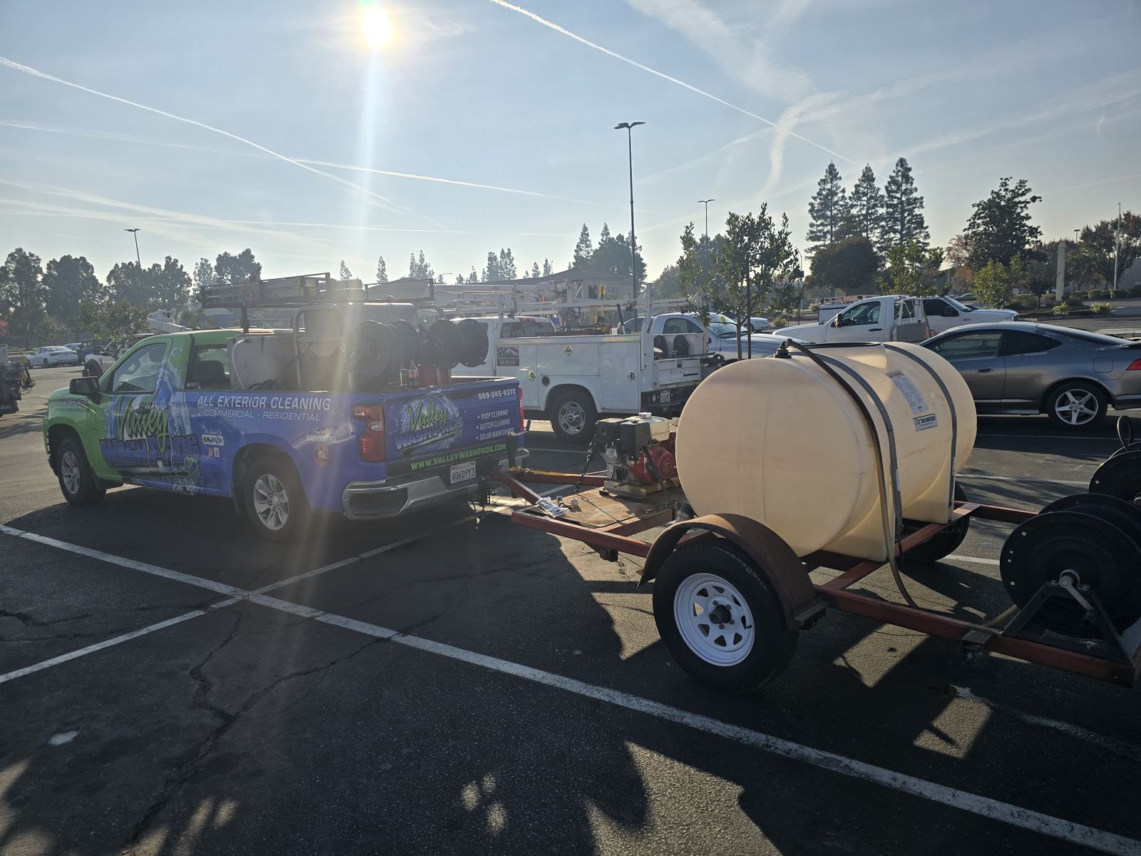 Valley Wash Pros truck towing a water tank trailer for large pressure washing jobs