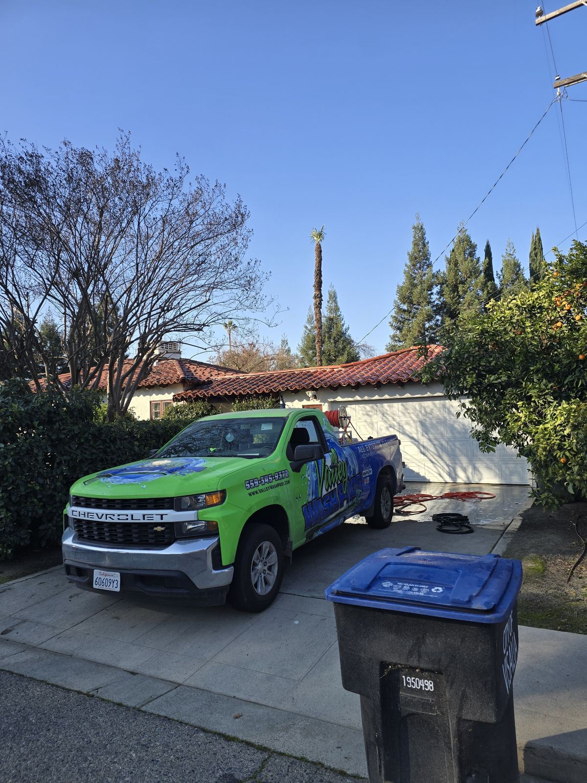 Valley Wash Pros truck in the driveway of a tile roof home for a roof cleaning