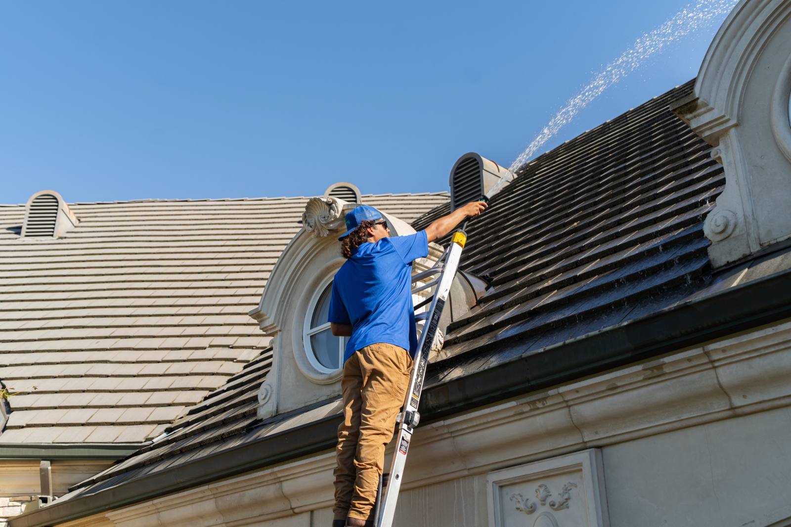 Soft wash roof cleaning lifting algae and moss off a roof in the Central Valley