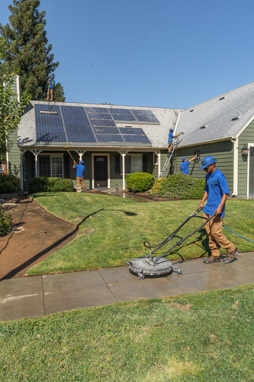 Valley Wash Pros crew cleaning a rooftop solar array and the driveway of a Central Valley home on the same visit