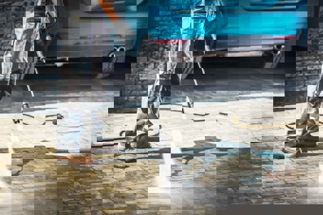 Pressure washing a driveway