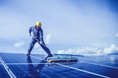 Man cleaning solar panels